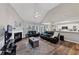 Bright living room with a vaulted ceiling, fireplace, and wood flooring leading to the kitchen at 2577 Twin Oaks Sw Dr, Marietta, GA 30064
