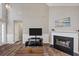 Living room with a fireplace, TV stand, and modern wooden floors at 2577 Twin Oaks Sw Dr, Marietta, GA 30064