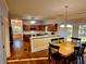 Bright kitchen with wooden cabinets, modern appliances, and a dining area with a chandelier at 3348 Summit Turf Ln, Snellville, GA 30078