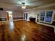 Bright living room with hardwood floors, a fireplace, and doors leading to the outside at 3348 Summit Turf Ln, Snellville, GA 30078