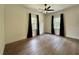 Spacious bedroom with hardwood floors, crown molding, natural light, and a ceiling fan at 3987 St Georges Ct, Duluth, GA 30096