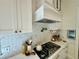 A close-up of a well-appointed kitchen featuring a tiled backsplash and stainless steel appliances at 3987 St Georges Ct, Duluth, GA 30096