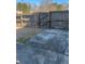 The fenced backyard features a mix of concrete and stone pavers and a small grass area at 1546 Mine Run, Hampton, GA 30228