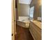 Bright bathroom featuring a garden tub, granite vanity, and earth-toned tiled flooring at 1546 Mine Run, Hampton, GA 30228