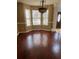 Dining room featuring wood laminate flooring, a bay window with blinds, and an ornate chandelier at 1546 Mine Run, Hampton, GA 30228