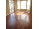 Dining room with hardwood flooring, a window with blinds, and a view of the backyard at 1546 Mine Run, Hampton, GA 30228