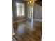 The dining room has wood-look tile flooring, natural light, and a modern chandelier above the table at 1546 Mine Run, Hampton, GA 30228