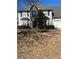 Traditional two-story home with a combination of stone and siding and a well-manicured lawn at 1546 Mine Run, Hampton, GA 30228