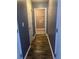 Hallway with wood-look floors leads to a storage area with a closet and access to laundry connections at 1546 Mine Run, Hampton, GA 30228