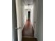 Hallway with wood floors that connects multiple rooms, featuring white walls and doors at 1546 Mine Run, Hampton, GA 30228