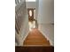 An interior staircase with wood steps and white railings leads to the upper level of the home at 1546 Mine Run, Hampton, GA 30228