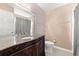 Bathroom featuring granite counters, wood cabinets, toilet, and a large mirror at 204 Summer Pl, Norcross, GA 30071