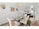 Elegant dining area with glass table, stylish chairs, and views into the adjacent living room at 204 Summer Pl, Norcross, GA 30071