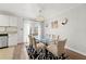 Dining room with a modern chandelier, a glass-top table, and access to outdoor light at 204 Summer Pl, Norcross, GA 30071