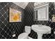 Chic powder room with black and white diamond pattern, pedestal sink, and decorative mirror at 204 Summer Pl, Norcross, GA 30071