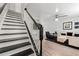 Elegant staircase with black and white accents leading into a stylishly decorated living area at 204 Summer Pl, Norcross, GA 30071