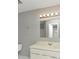 This bathroom features a standard vanity, mirror with lighting, and neutral walls at 2223 Wingate Sw St, Atlanta, GA 30310