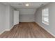 Spacious bedroom features new wood-look floors, neutral paint, and a window for natural light at 2223 Wingate Sw St, Atlanta, GA 30310