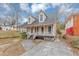 Charming two-story home with a welcoming front porch and well-maintained yard, perfect for relaxing outdoors at 2223 Wingate Sw St, Atlanta, GA 30310