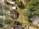 Aerial view of the property showing the house, driveway, shed, and surrounding mature trees and landscaping at 4100 Brown Rd, Tucker, GA 30084