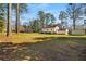 Spacious backyard showcasing the home's rear exterior, a storage shed, and plenty of open green space at 4100 Brown Rd, Tucker, GA 30084