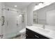 Contemporary bathroom featuring glass shower door, blue accent tile and modern vanity at 4100 Brown Rd, Tucker, GA 30084