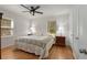 Cozy bedroom featuring hardwood floors, ceiling fan and two windows for plenty of natural light at 4100 Brown Rd, Tucker, GA 30084