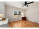 Bedroom with hardwood floors, ceiling fan and window with views of the surrounding nature at 4100 Brown Rd, Tucker, GA 30084