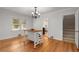 Bright dining area with hardwood floors and a view into the staircase for an inviting space at 4100 Brown Rd, Tucker, GA 30084