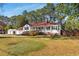 Lovely front lawn view of home, with a wide wheelchair ramp, and two car detached garage at 4100 Brown Rd, Tucker, GA 30084