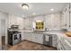 Updated kitchen featuring stone countertops, neutral backsplash, and stainless-steel appliances at 4100 Brown Rd, Tucker, GA 30084