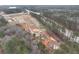 An aerial view of a new construction site, featuring roads, lots, and nearby mature trees and homes at 4525 Twinberry Dr, Powder Springs, GA 30127