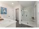 Bright bathroom featuring a spacious glass shower with marble tile, modern fixtures, and decorative floor at 4525 Twinberry Dr, Powder Springs, GA 30127