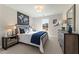 Bedroom features a large window, side tables with lamps, a dresser and stylish wall art at 4525 Twinberry Dr, Powder Springs, GA 30127