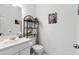 Bright bathroom with modern sink and stylish black metal shelving unit at 5968 Eagle Tiff Ln, Sugar Hill, GA 30518