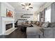 Comfortable living room with a gray sectional sofa, fireplace, and floating shelves at 5968 Eagle Tiff Ln, Sugar Hill, GA 30518