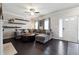 Comfortable living room with a gray sectional sofa, fireplace, and floating shelves at 5968 Eagle Tiff Ln, Sugar Hill, GA 30518