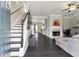 Inviting living room featuring hardwood floors, a fireplace, and a staircase at 5968 Eagle Tiff Ln, Sugar Hill, GA 30518