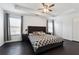 Spacious main bedroom with tray ceiling, ceiling fan, and lots of natural light at 5968 Eagle Tiff Ln, Sugar Hill, GA 30518