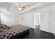 Generous bedroom featuring dark hardwood flooring, ceiling fan, and multiple closets at 5968 Eagle Tiff Ln, Sugar Hill, GA 30518