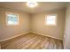 Bright bedroom features wood-look flooring, light walls, and two windows for ample natural light at 810 Gettysburg Trl, Kennesaw, GA 30144