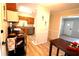 Kitchen featuring modern appliances, granite countertops, wood cabinetry, and stylish flooring at 810 Gettysburg Trl, Kennesaw, GA 30144