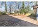 Large backyard with a wood fence and mature trees providing shade and privacy at 1889 Cannon St, Decatur, GA 30032