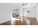 Bright living room featuring hardwood floors, fresh paint, ceiling fan and open access to the modern kitchen at 1889 Cannon St, Decatur, GA 30032