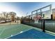 Outdoor basketball court with green and blue painted surface and adjustable basketball hoop at 2075 Crabapple Parc Way, Roswell, GA 30076