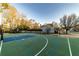 Outdoor basketball court fenced in with a home in the background for recreation and exercise at 2075 Crabapple Parc Way, Roswell, GA 30076