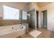 Bright bathroom featuring a soaking tub and glass-enclosed shower at 2075 Crabapple Parc Way, Roswell, GA 30076