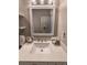 Bathroom featuring a white sink and square mirror, with decorative light fixture at 2075 Crabapple Parc Way, Roswell, GA 30076