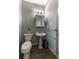 Charming half bath featuring a pedestal sink, vintage-style faucet, and an updated modern toilet at 2075 Crabapple Parc Way, Roswell, GA 30076