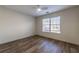 This bedroom has wood laminate flooring, a ceiling fan and a sunny window with blinds at 2075 Crabapple Parc Way, Roswell, GA 30076